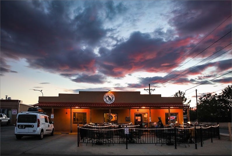 A **brewery** at dusk with a cloudy sky in the background.